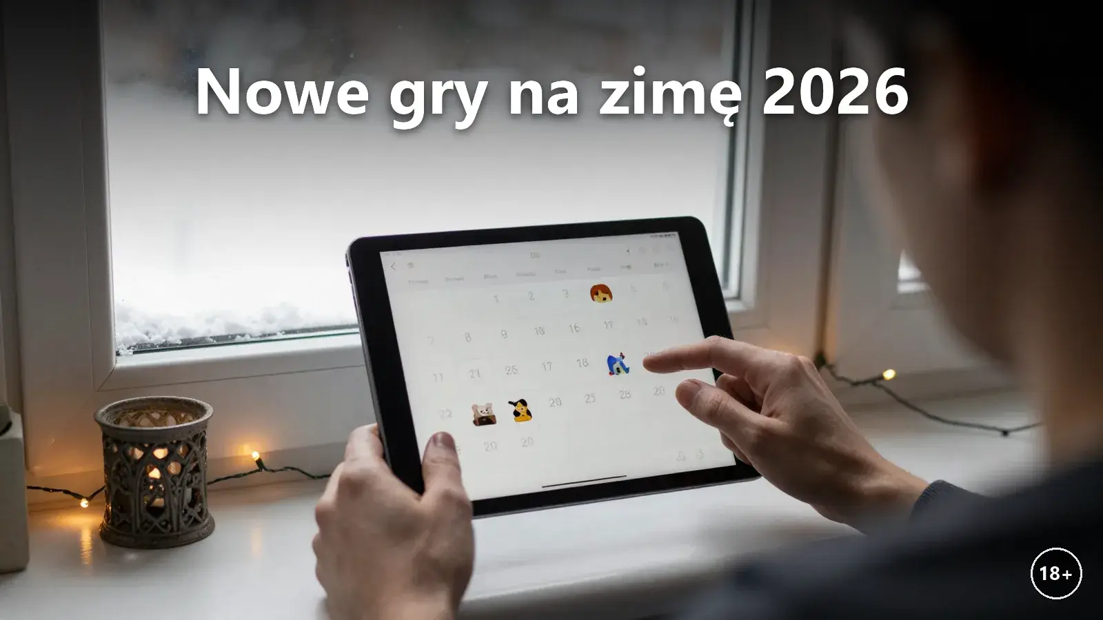Tablet z kalendarzem premier gier kasynowych na zimowym parapecie
