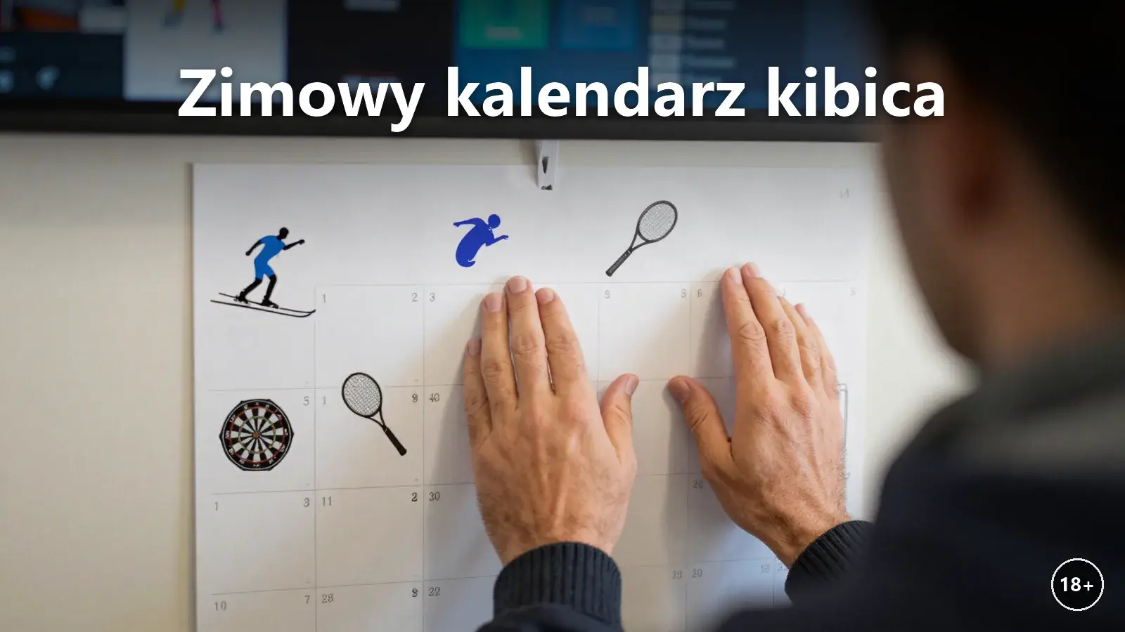 Kibic w szaliku przed ścianą kalendarza zimowych wydarzeń sportowych